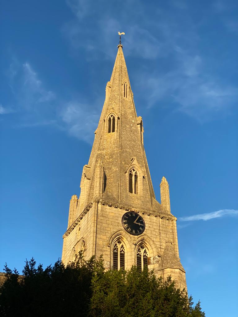 St Mary the Virgin — spire and clock tower in golden evening light, Wollaston